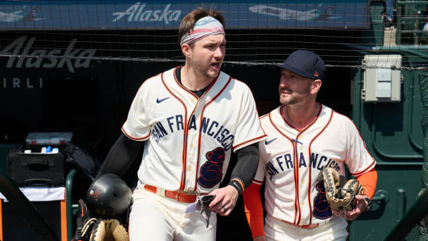 Aug 26, 2023; San Francisco, California, USA; San Francisco Giants catcher Patrick Bailey (14) and bullpen/catching coach Craig Albernaz (0) walk onto the field wearing San Francisco Sea Lions jerseys in honor of the Negro League team that played in San Francisco for one season in 1946 as part of the club's celebration of African American Heritage before the game against the Atlanta Braves at Oracle Park.